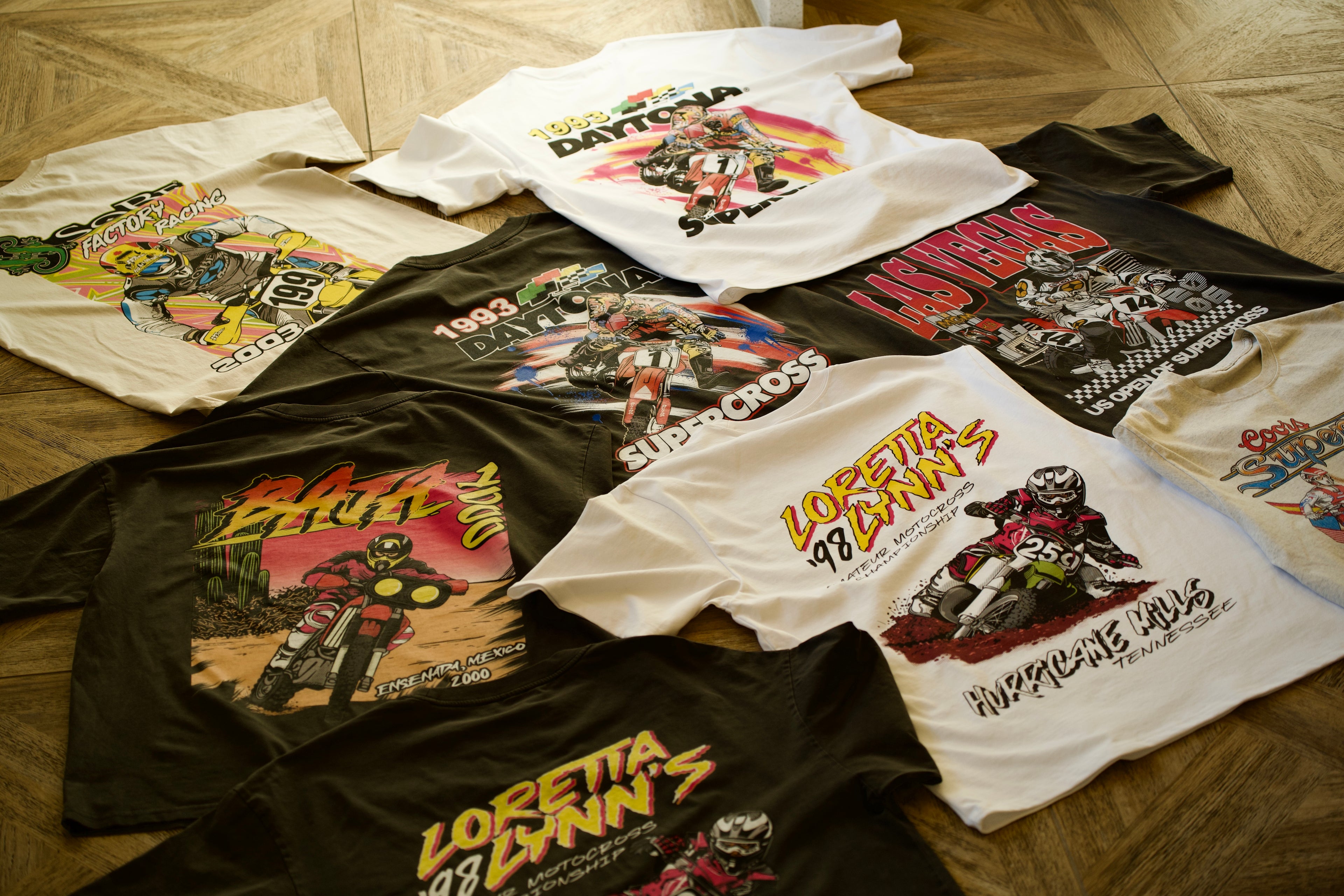 A collection of various vintage motocross shirts.