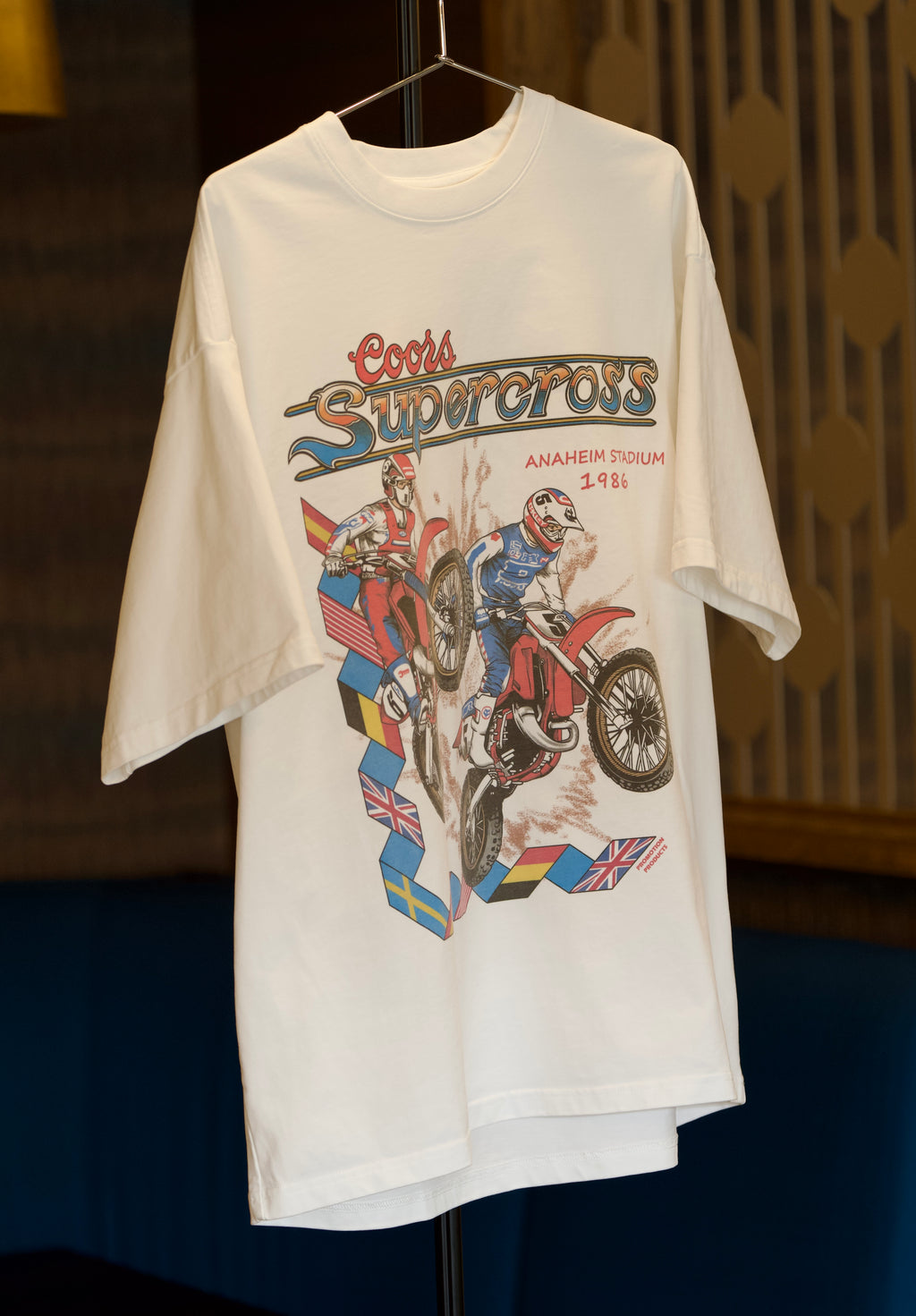 Vintage t-shirt with Coors Supercross graphic design on a hanger.