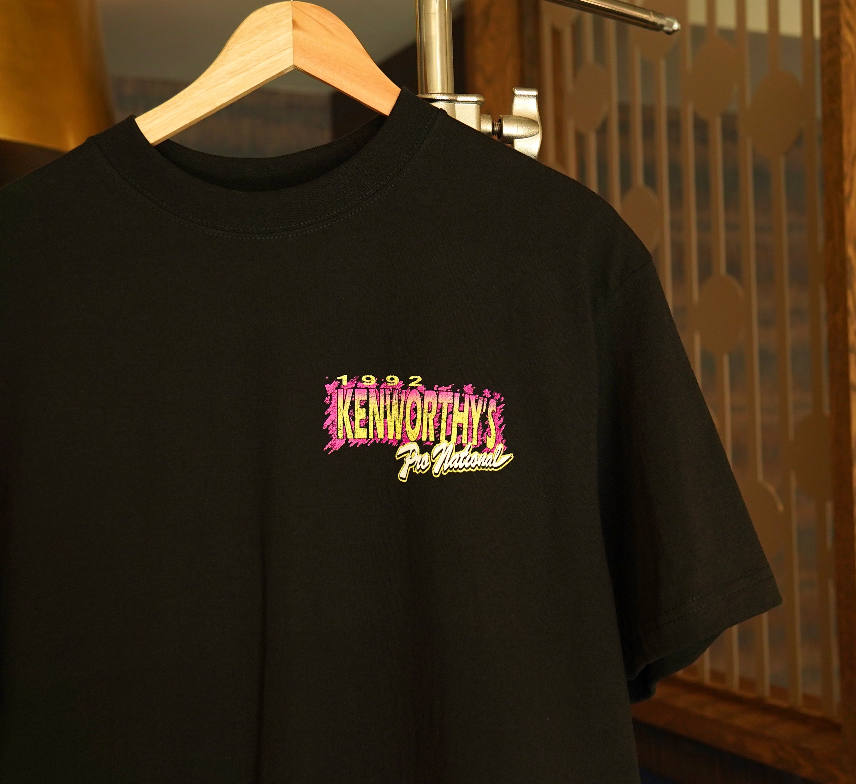 A black short-sleeve t-shirt featuring a colorful chest graphic that reads Kenworthy's Pro Motocross National 1992.