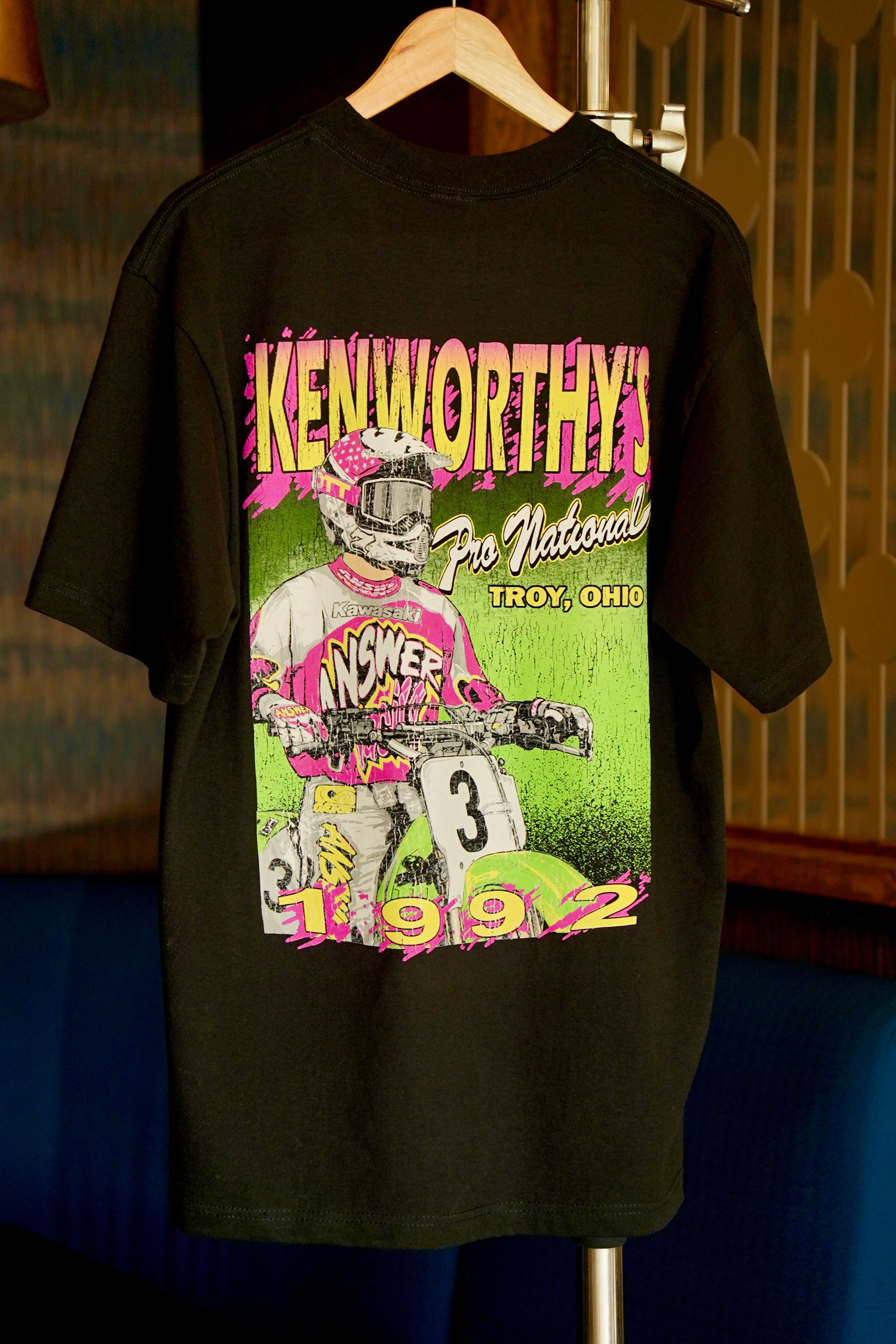 A vintage shirt for the 1992 Kenworthy's Motocross National in Troy, Ohio featuring a rider on a Kawasaki KX250.