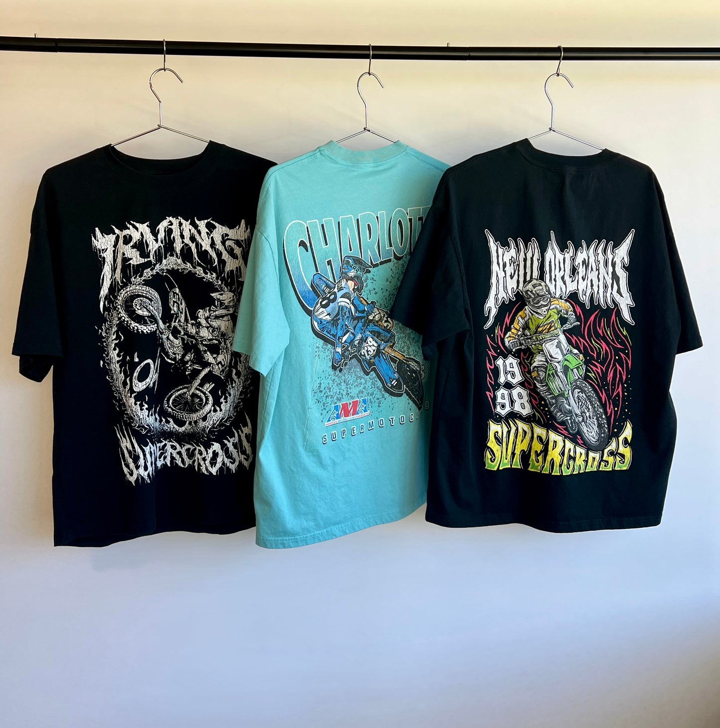 A picture of 3 vintage inspired supercross racing streetwear shirts.